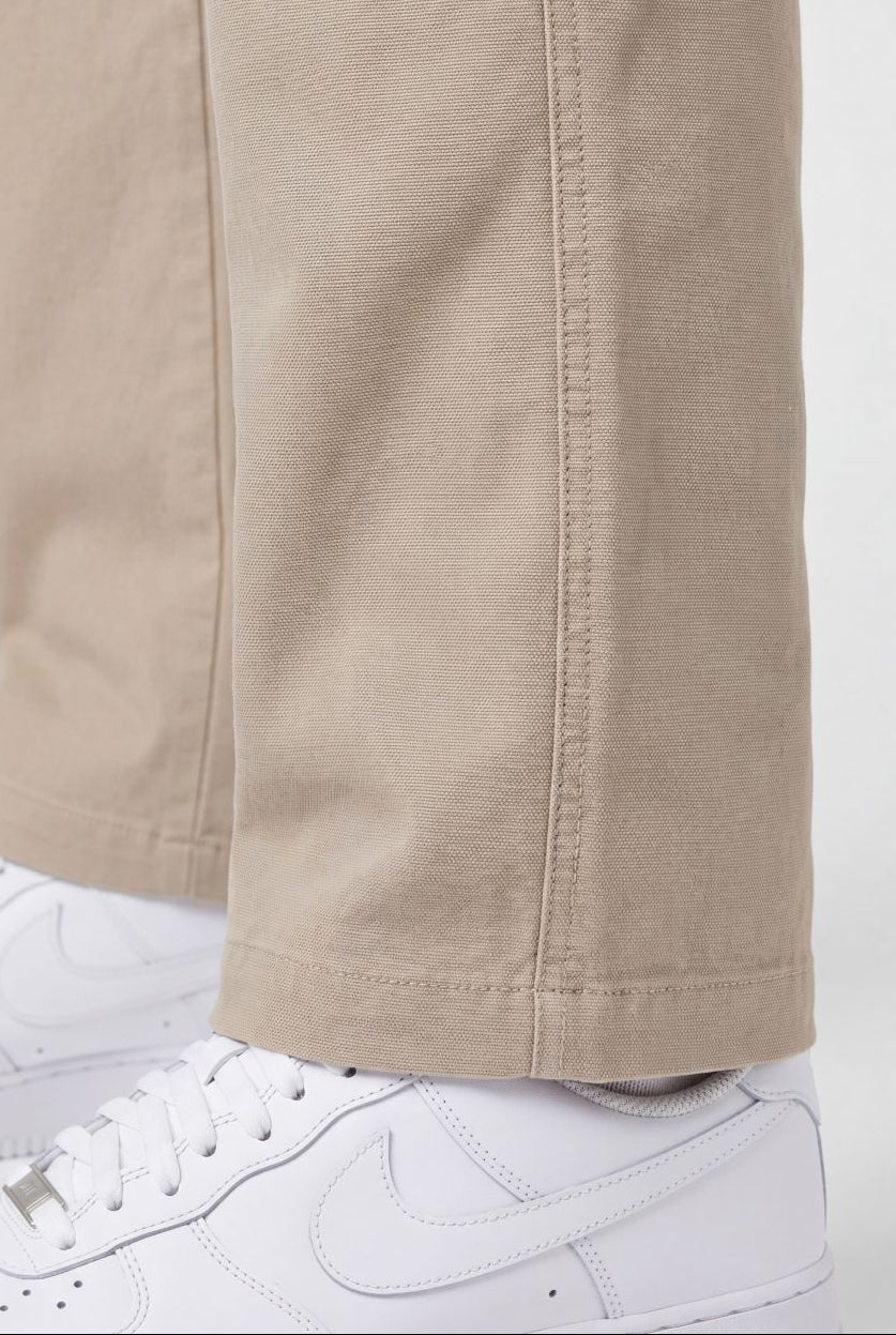 Beige pants with white sneakers on a white background