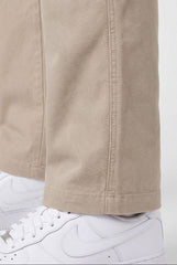 Beige pants with white sneakers on a white background