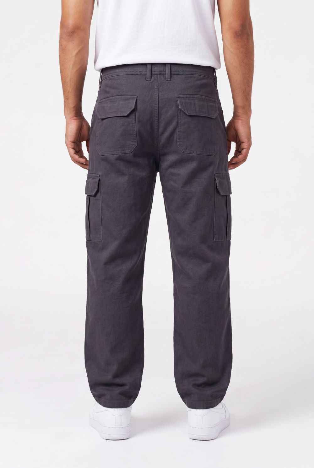 Person wearing dark gray cargo pants on a white background