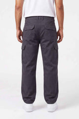 Person wearing dark gray cargo pants on a white background